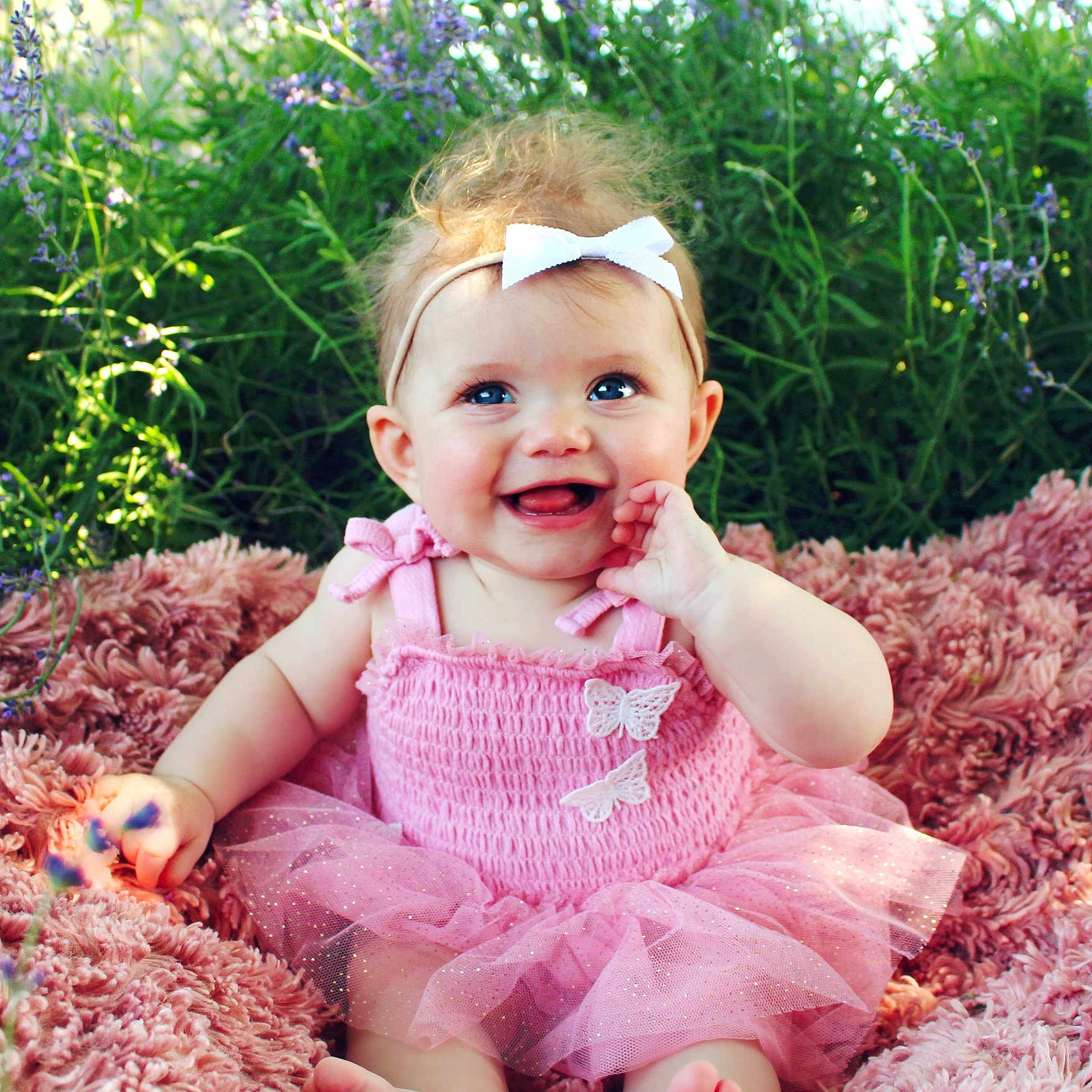 Emma joined the competition — help win amazing prizes! baby, blanket, blue_eyes, bow_headband, butterfly_applique, child, cute, flowers, greenery, happy, infant, nature, outdoor, pink_dress, portrait, sitting, smiling, soft_texture, sunlight, tulle_skirt