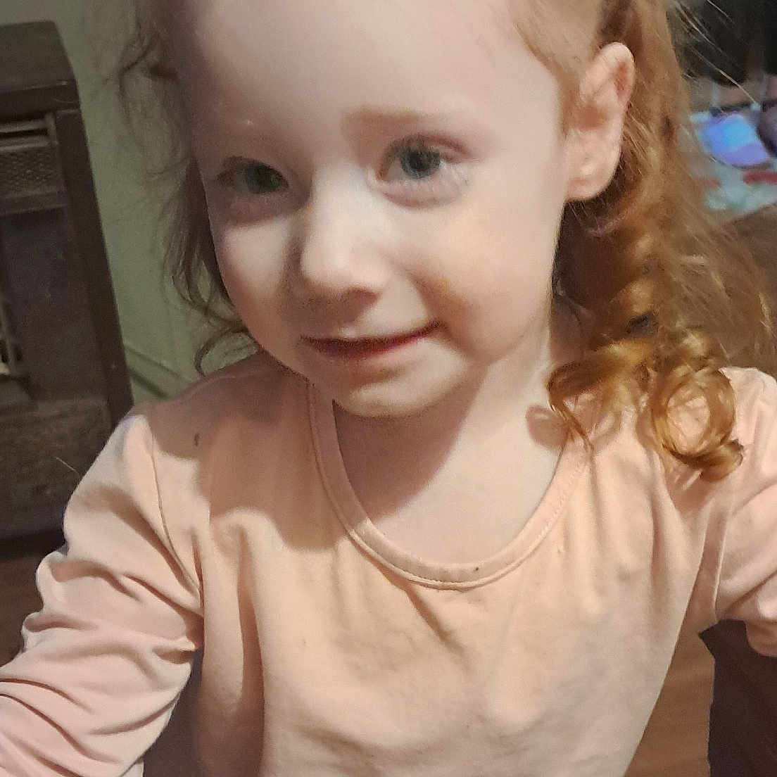 Josie-Bee joined the competition — help win amazing prizes! casual, child, childhood, curly_hair, cute, face, furniture, girl, hair_clip, happy, indoor, long_sleeve, person, portrait, red_hair, shirt, smile, standing, wood_floor, young