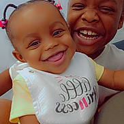 Sevyn is registered to the contest to win money with this photo: baby, bib, child, closeup, clothing, cute, expression, face, family, hair, happy, indoors, joy, laughing, people, portrait, sibling, skin, smiling, toddler