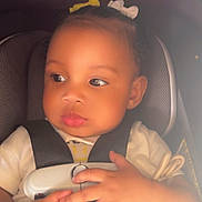 Naylani is registered to the contest to win money with this photo: baby, baby_toys, car_seat, child, closeup, clothing, cute, gaze, hair_bow, hands, indoors, infant, infant_clothing, pacifier, person, portrait, safety_harness, seat, seatbelt, young_child