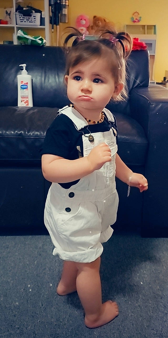 Maya joined the competition — help win amazing prizes! baby_toddler_clothing, child, cool, couch, electric_blue, facial_expression, flash_photography, fun, gesture, happy, joint, one_piece_garment, pattern, person, photograph, skin, sleeve, snapshot, standing, toddler