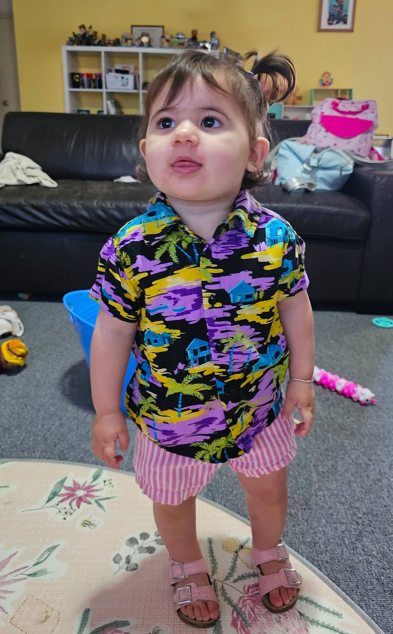 Maya is registered to the contest to win money with this photo: baby_toddler_clothing, child, couch, event, face, flooring, fun, happy, leisure, magenta, pattern, person, pink, plant, play, purple, sandal, sitting, skin, sleeve