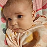 baby, infant, face, closeup, blanket, soft_fabric, child, cute, portrait, expression, indoors, resting, head, eyes, skin, clothing, colorful, pattern, polka_dots, young