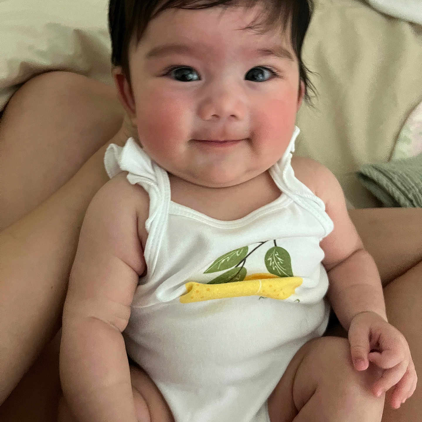 Rhylee is registered to the contest to win money with this photo: baby, child, infant, smile, face, arm, skin, onesie, clothing, person, cute, happy, indoor, human, portrait, sitting, closeup, head, expression, young