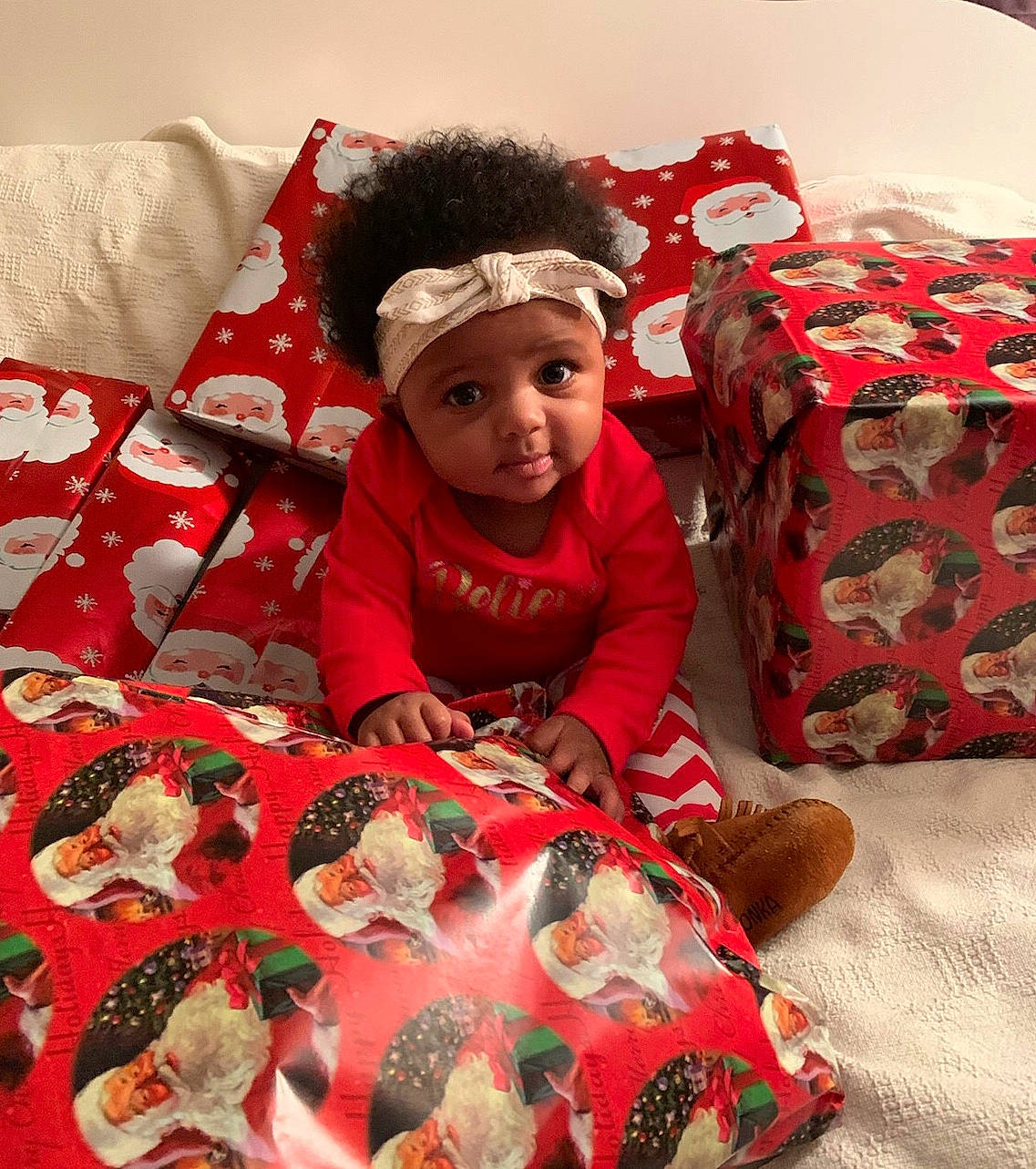 Kimani joined the competition — help win amazing prizes! baby, bed_sheet, bedding, child, christmas, christmas_eve, cushion, headwear, linens, person, play, quilt, red, textile, toddler