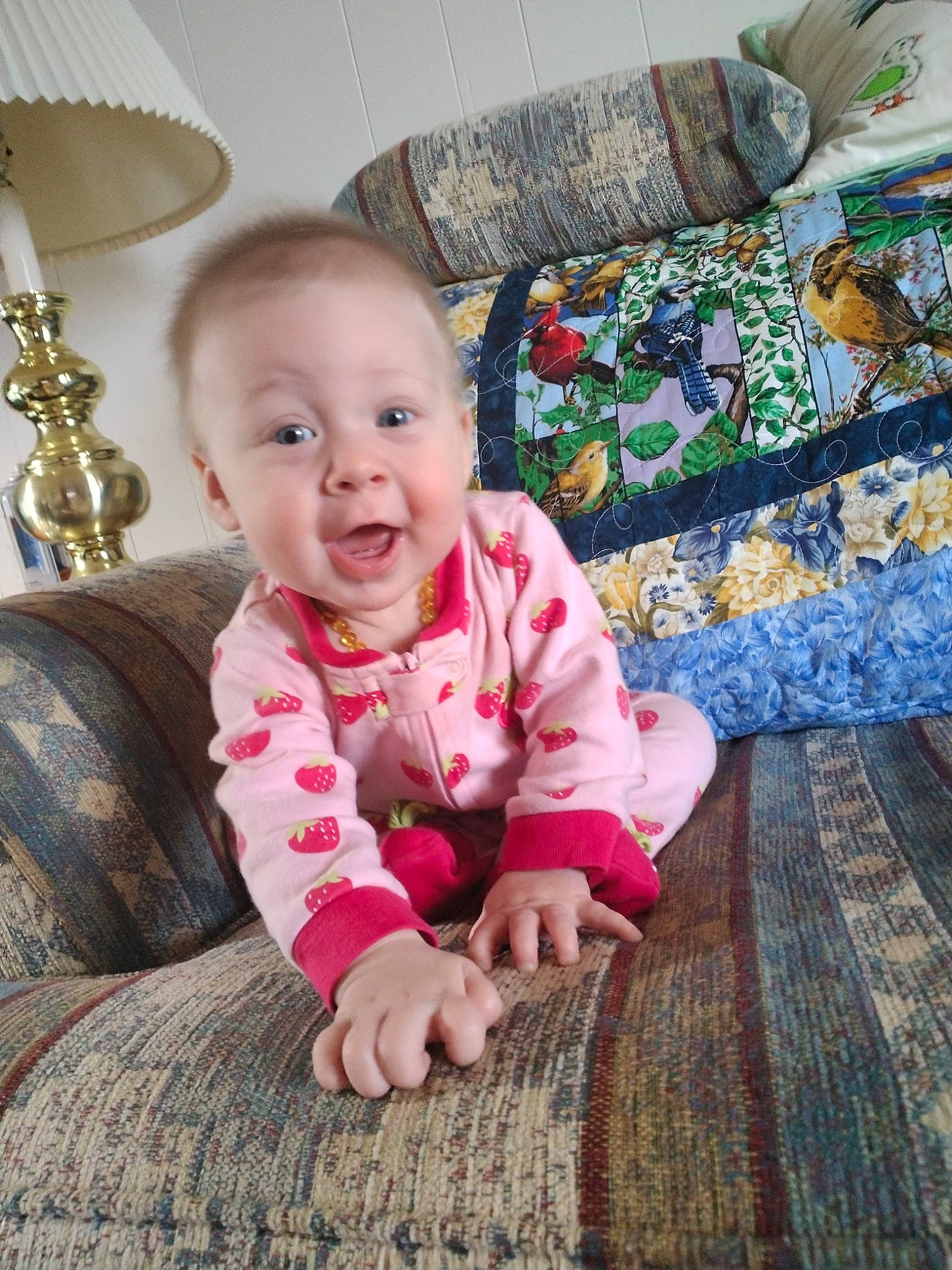 Kyla joined the competition — help win amazing prizes! baby, baby_toddler_clothing, cheek, child, comfort, couch, eye, floor, flooring, happy, linens, outerwear, pattern, person, sitting, skin, sleeve, smile, textile, toddler