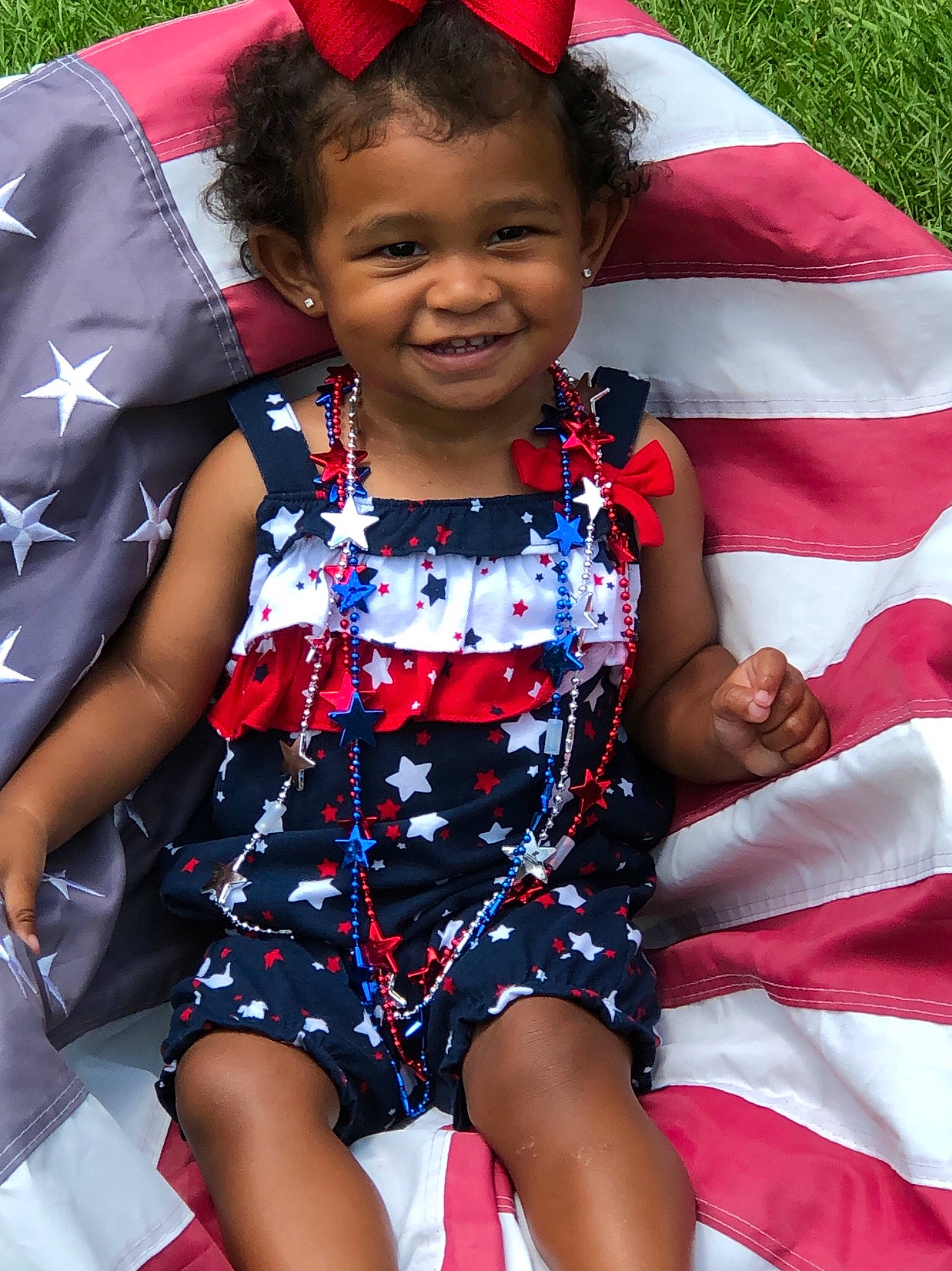 Kaleah joined the competition — help win amazing prizes! baby, baby_toddler_clothing, costume_accessory, day_dress, embellishment, hair_accessory, happy, headband, headgear, headpiece, joy, mouth, nose, one_piece_garment, pattern, person, red, summer, toddler
