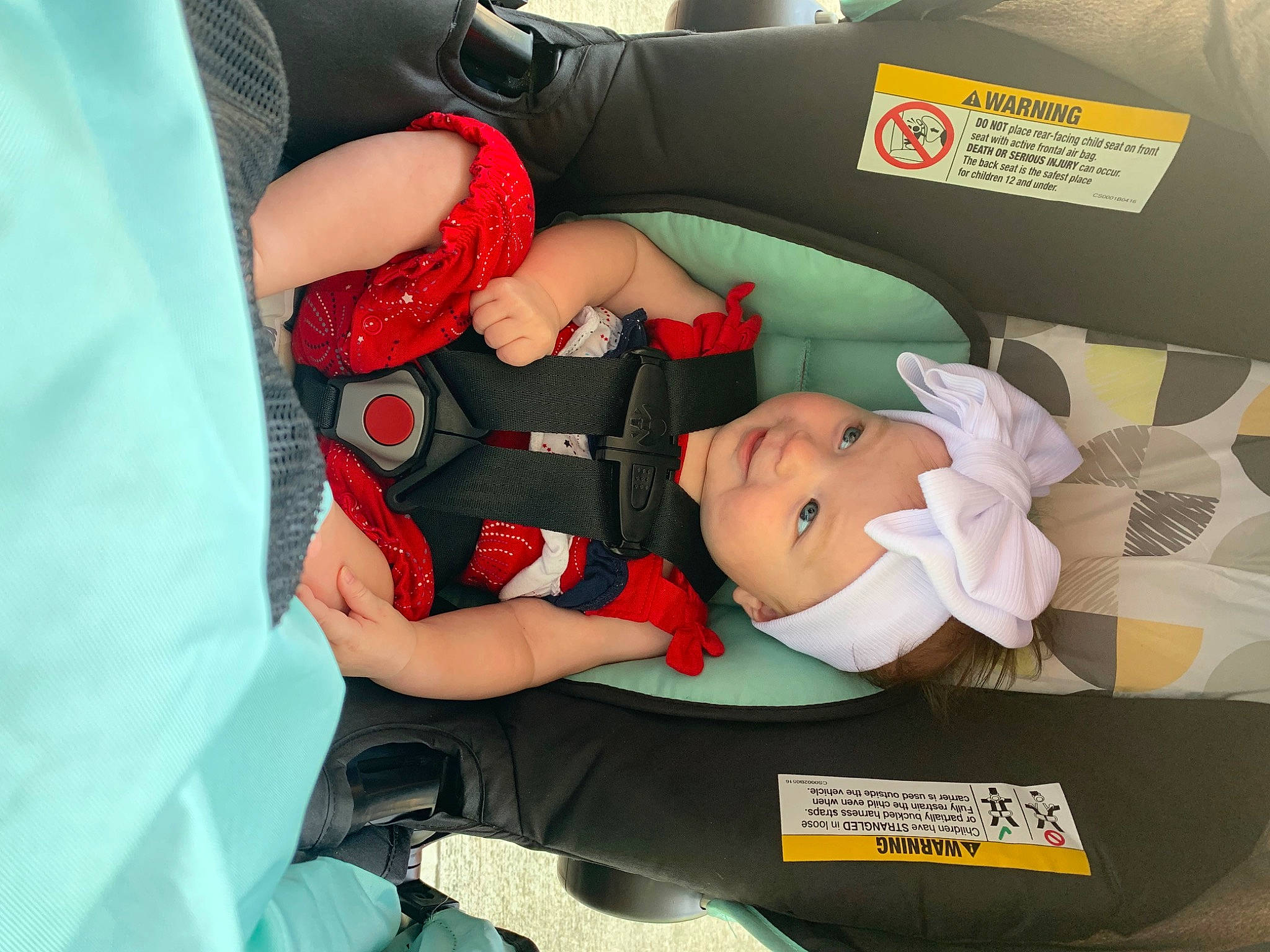Guinevere is registered to the contest to win money with this photo: baby, baby_carriage, baby_products, baby_toddler_clothing, car_seat, carmine, child, comfort, elbow, hat, headwear, lap, person, room, sitting, sock, thigh, toddler