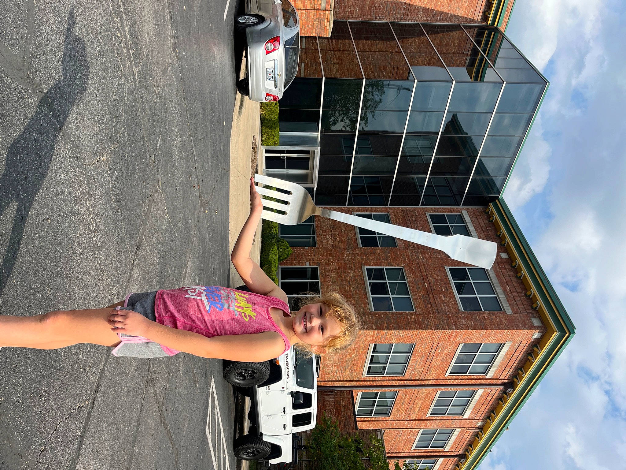 Addi joined the competition — help win amazing prizes! asphalt, building, car, cloud, facade, fun, house, human_leg, joy, line, material_property, neighbourhood, person, road, shorts, sky, thigh, tire, tree, wall