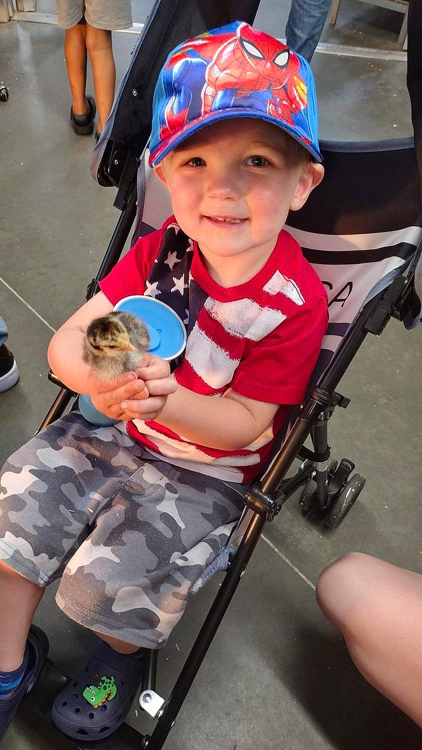 Wyatt is registered to the contest to win money with this photo: baby, baby_carriage, baby_toddler_clothing, baseball_cap, cap, child, face, fun, hat, headwear, joy, leg, leisure, person, product, shorts, skin, smile, snapshot, thigh