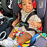 Taevon is registered to the contest to win money with this photo: baby, car_seat, toy, child, car_interior, seat_belt, sneakers, colorful, infant, sitting, plastic_toy, vehicle, clothing, seat, child_safety, cute, play, interior, person, young_child