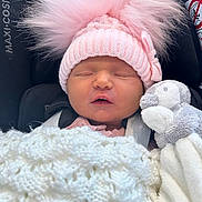 Bree is registered to the contest to win money with this photo: baby, blanket, bundle, bunny, car_seat, child, cozy, cute, fluffy_pom_poms, headwear, indoors, infant, newborn, pink_hat, plush_toy, portrait, resting, sleeping, soft, warm
