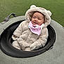 Bree is registered to the contest to win money with this photo: baby, baby_fashion, bear_ears, child, circular_seat, cozy, cute, fluffy_costume, grass, headwear, infant, outdoor, padded_seat, pink_bib, play_area, portrait, sitting, smiling, soft_texture, warm_clothing
