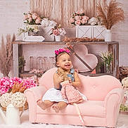 Angelina is registered to the contest to win money with this photo: toddler, child, pink_couch, doll, flowers, decor, heart, shelf, pink_bows, smile, happy, indoor, plush_toy, white_dress, rustic, girl, cute, soft_tones, homedecor, photography