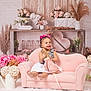 toddler, child, pink_couch, doll, flowers, decor, heart, shelf, pink_bows, smile, happy, indoor, plush_toy, white_dress, rustic, girl, cute, soft_tones, homedecor, photography