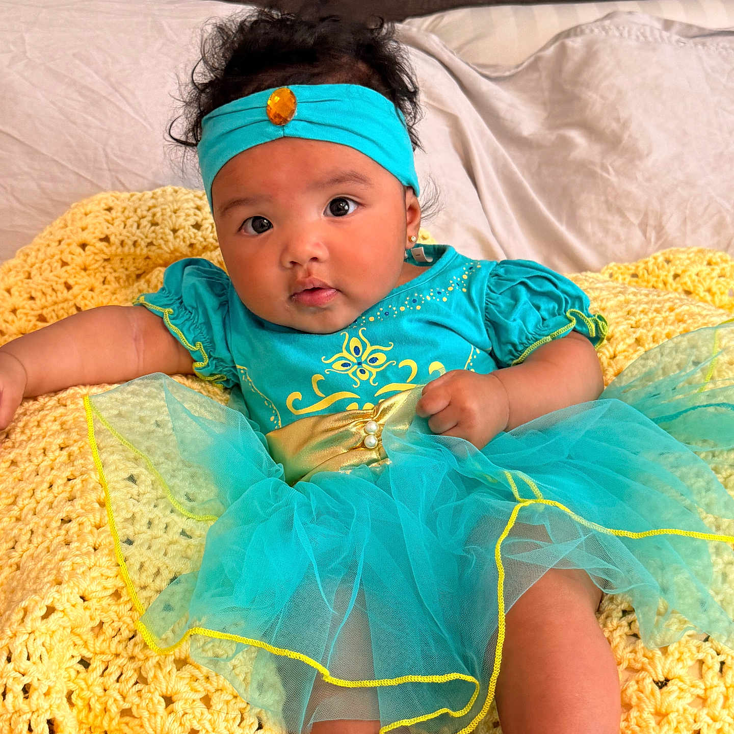 Berlin joined the competition — help win amazing prizes! baby, infant, tutu_dress, headband, yellow_blanket, crocheted_blanket, blue_clothing, cute, child, portrait, indoors, soft_lighting, happy, smiling, sitting, curly_hair, person, closeup, adorable, cozy