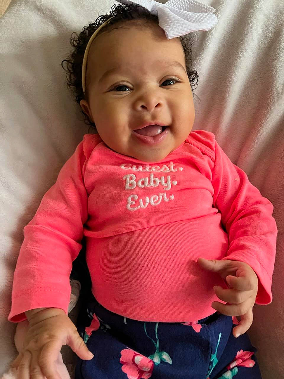 Alina is registered to the contest to win money with this photo: baby, baby_toddler_clothing, cheek, child, comfort, cool, eye, facial_expression, finger, gesture, happy, human, iris, organ, person, pink, skin, sleeve, smile, textile