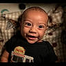 baby, smiling, face, child, black_shirt, taco, patterned_blanket, happy, portrait, indoors, cute, infant, closeup, young_child, head, eyes, mouth, toddler, clothing, person
