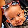 Keaton joined the competition — help win amazing prizes! baby, child, face, smile, sunglasses, red_sunglasses, leopard_print, baby_carrier, person, cute, happy, infant, closeup, headwear, portrait, fashion, apparel, young_child, bright, expression