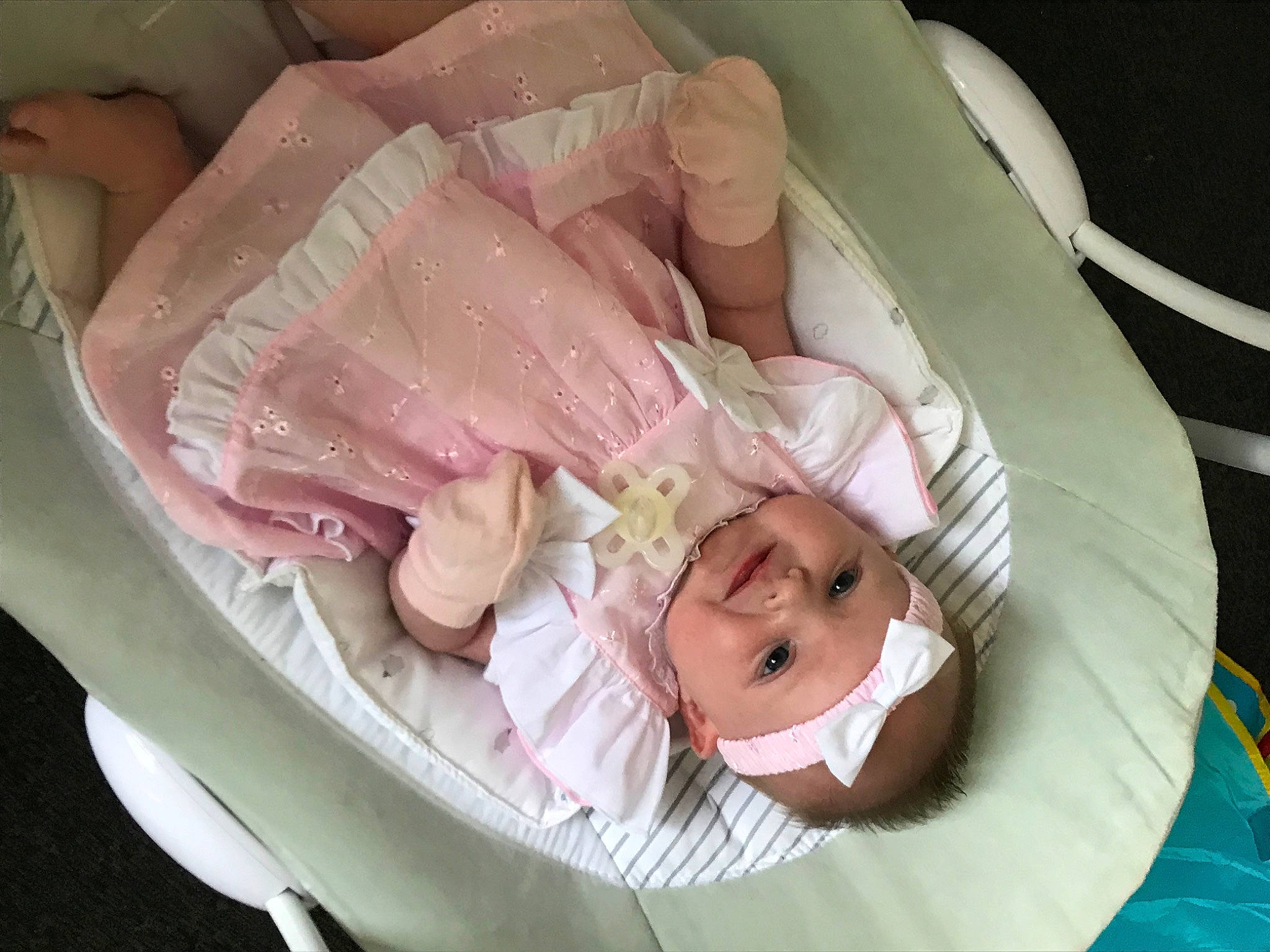 Harlow is registered to the contest to win money with this photo: baby, baby_carriage, baby_products, baby_safety, child, circle, comfort, event, finger, flesh, head, headwear, linens, peach, person, pink, rose, rose_order, sitting, smile