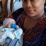 newborn, baby, woman, hospital_bed, blanket, pacifier, swaddled, indoor, portrait, mother, infant, headwear, comfort, healthcare, patient, hospital_room, smile, family, rest, care