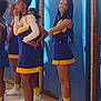 cheerleader, gymnasium, uniform, sports, team, smile, posing, young_person, blue, yellow, white_shoes, indoor, floor, wall_padding, window, group, people, standing, athlete, sport