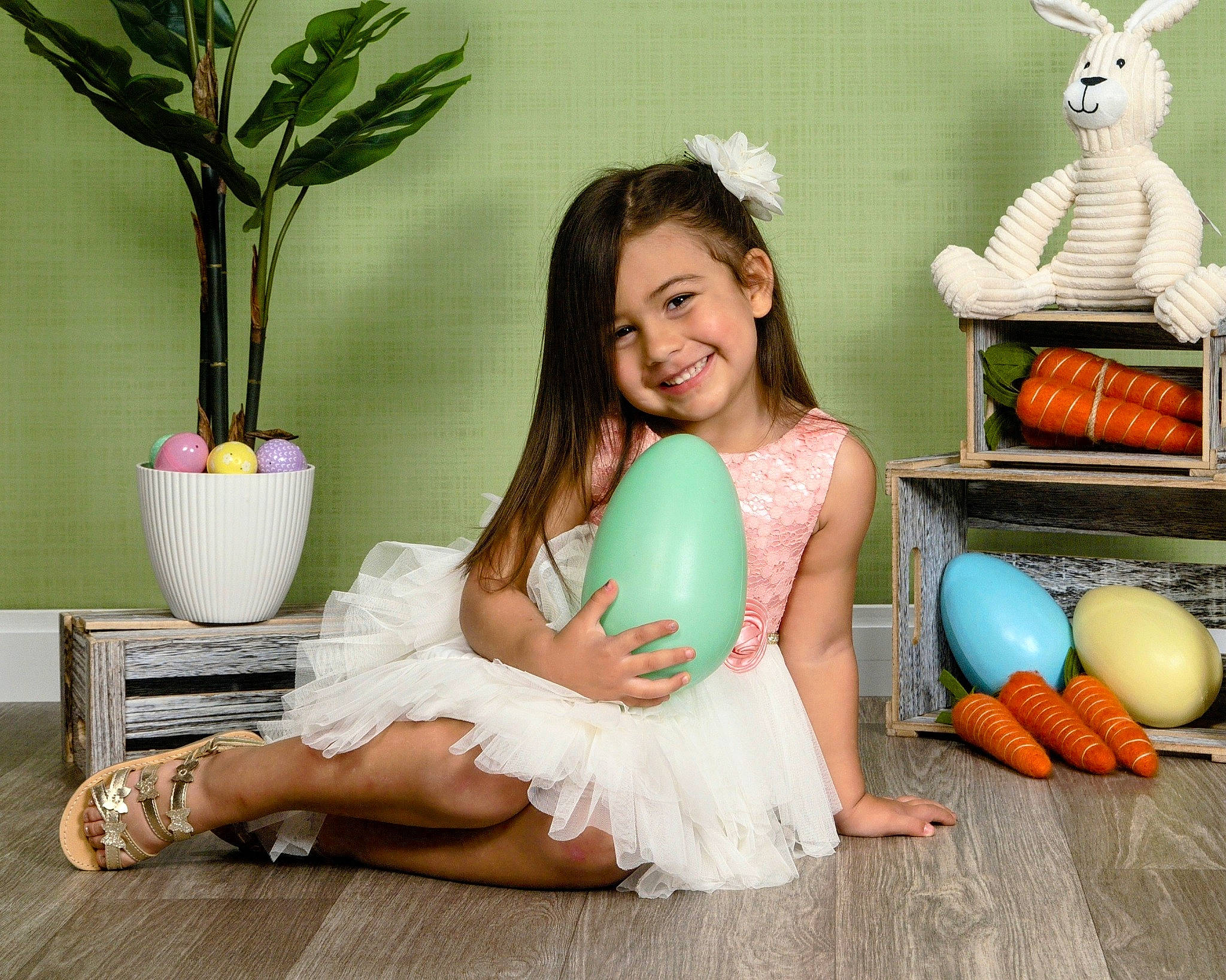 Tayla is registered to the contest to win money with this photo: barefoot, child, flowerpot, foot, fun, grass, green, happy, houseplant, human_leg, joy, leg, person, plant, room, sandal, shoe, sitting, smile, thigh