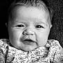baby, infant, face, portrait, black_and_white, expression, clothing, floral_pattern, closeup, skin, hair, eyes, mouth, newborn, cute, person, child, texture, soft_lighting, background