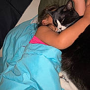 Pickles And Sofia is registered to the contest to win money with this photo: child, cat, black_and_white_cat, blanket, couch, hugging, cozy, indoor, sleeping, pet, affection, resting, comfort, feline, cute, together, arm, pink_shirt, relaxation, home