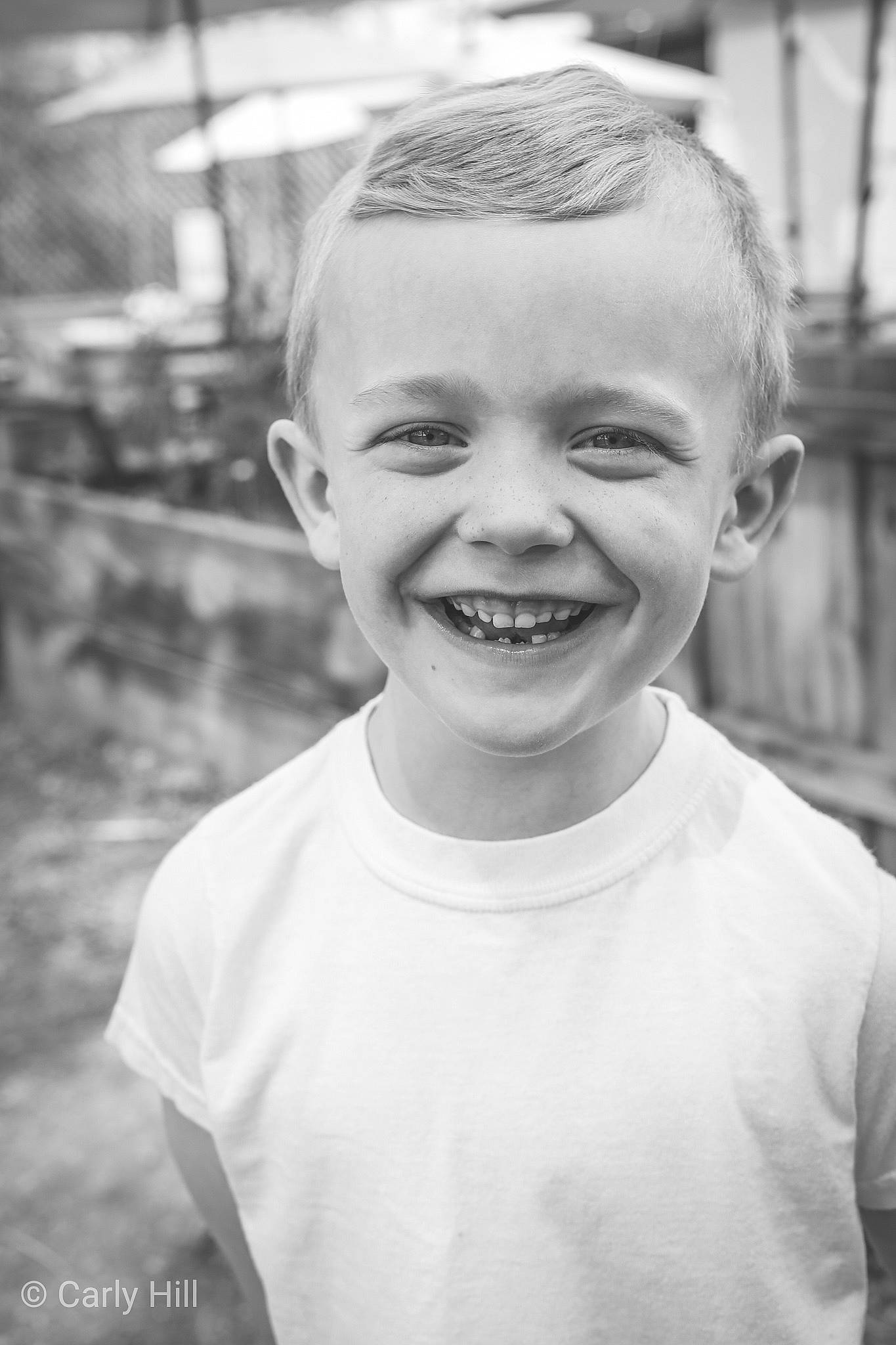 Jude is registered to the contest to win money with this photo: black, black_and_white, child, chin, eye, face, facial_expression, forehead, hairstyle, happy, head, joy, laugh, male, monochrome, monochrome_photography, people, person, photograph, smile
