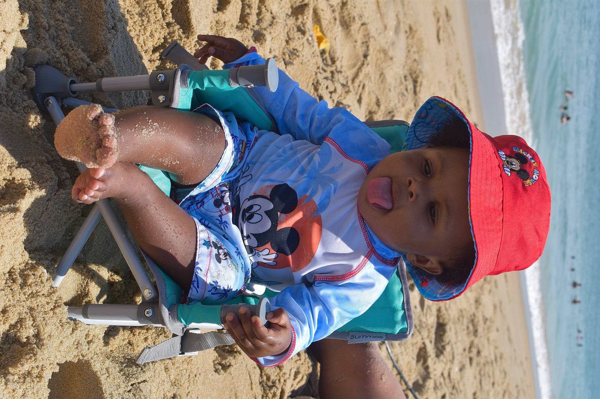 Landyn is registered to the contest to win money with this photo: azure, baseball_cap, beach, competition_event, electric_blue, fun, hat, headwear, landscape, leg, leisure, mammal, natural_environment, outdoor_recreation, person, recreation, shorts, sneakers, t_shirt, thigh