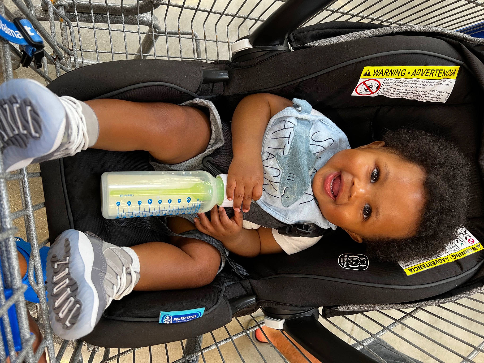 Landyn is registered to the contest to win money with this photo: baby_carriage, baby_products, bag, baggage, child, comfort, fun, human_leg, knee, lap, luggage_and_bags, passenger, person, shorts, thigh, toddler, transport, travel, walking_shoe