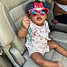 baby, child, sunglasses, minnie_mouse, car_seat, pacifier_clip, beads, clothing, person, infant, seat, leather, interior, hand, cute, accessory, pink, white, toy, car