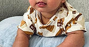 Christopher joined the competition — help win amazing prizes! baby, blanket, blue_eyes, brown_hair, child, close_up, couch, gold_toy, indoor, infant, onesie, patterned_clothing, pillow, portrait, sitting, smiling, soft_lighting, tongue_out, toy, wide_eyes