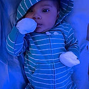 Keyon joined the competition — help win amazing prizes! baby, infant, onesie, hood, striped_clothing, blue_color, mittens, lying_down, blanket, soft_fabric, closeup, face, cute, child, sleepwear, indoors, portrait, baby_clothes, young_child, calm