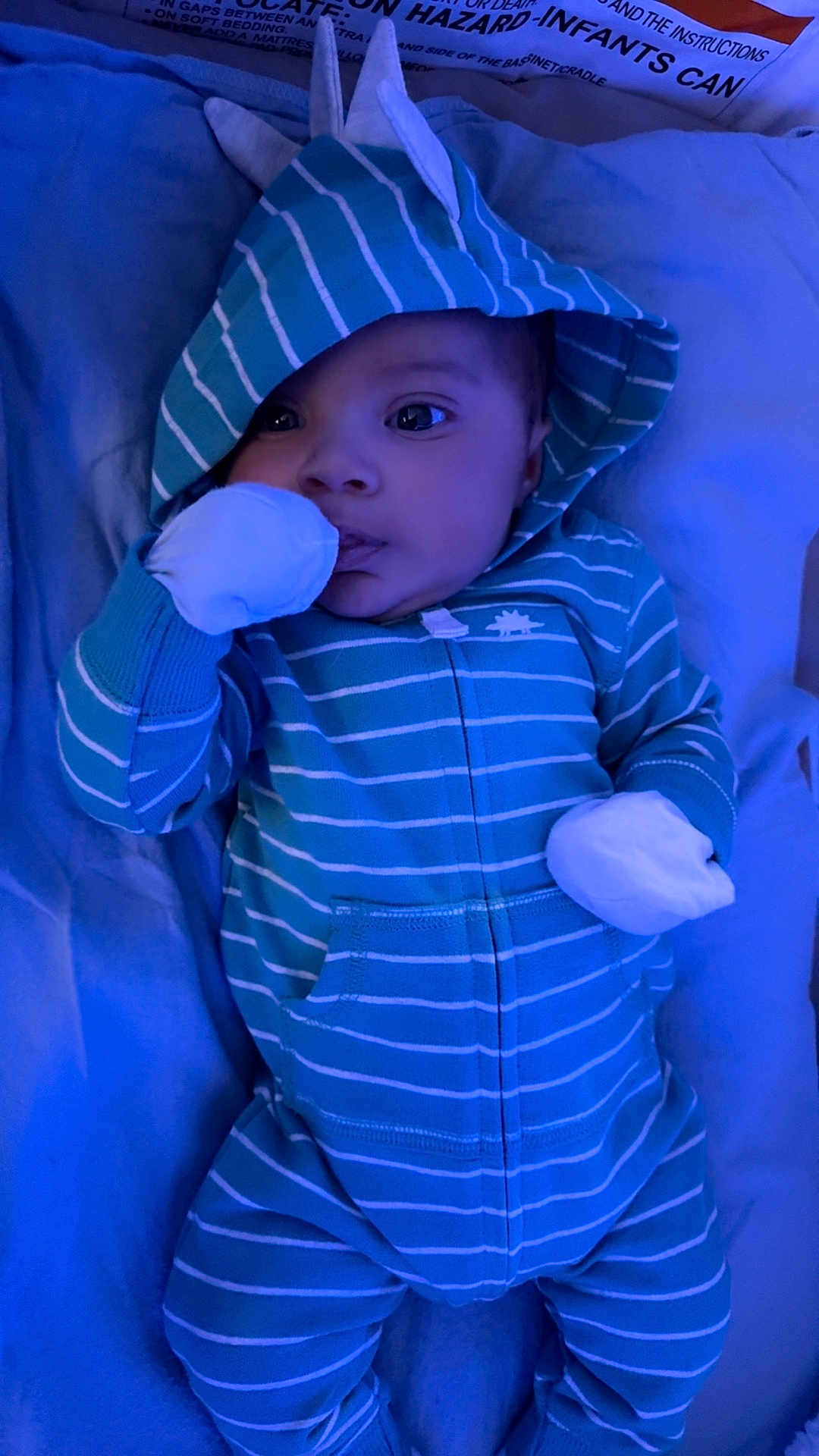 Keyon joined the competition — help win amazing prizes! baby, infant, onesie, hood, striped_clothing, blue_color, mittens, lying_down, blanket, soft_fabric, closeup, face, cute, child, sleepwear, indoors, portrait, baby_clothes, young_child, calm