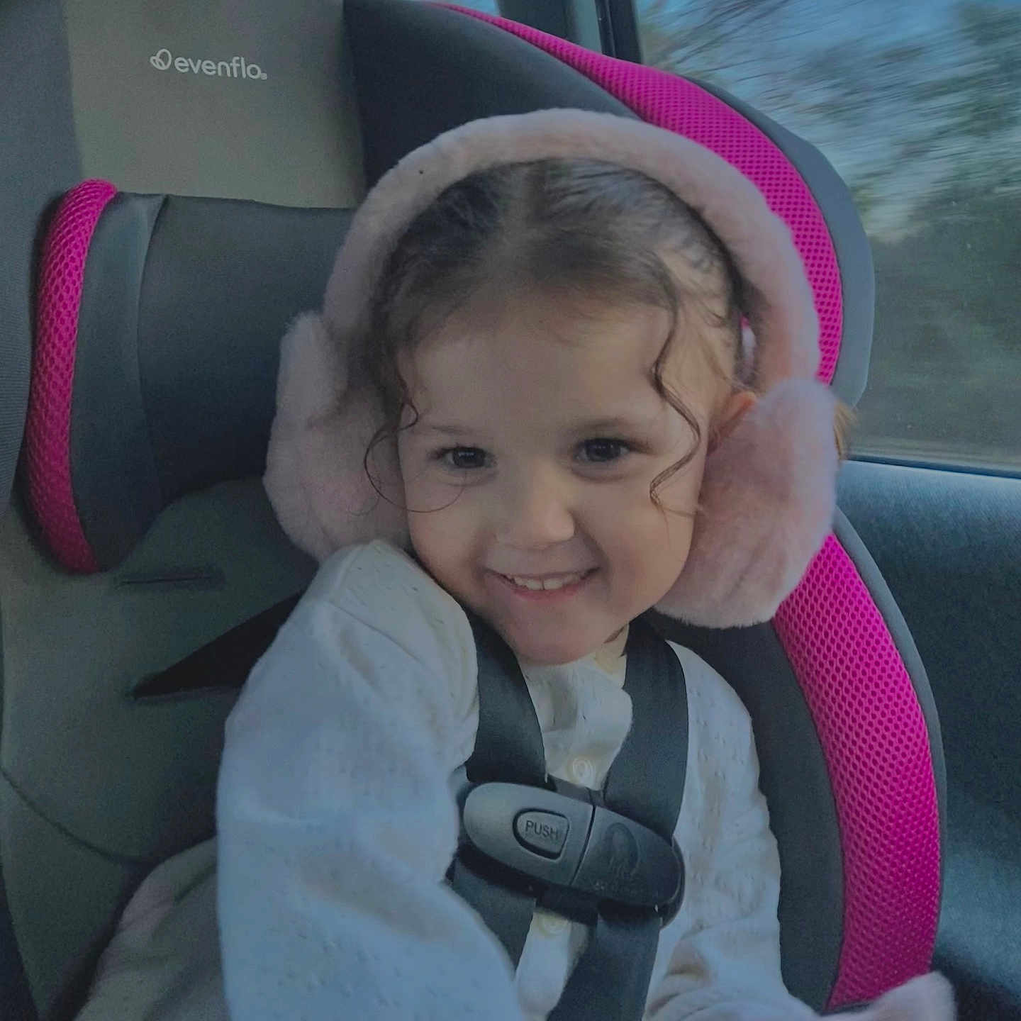 Promiss joined the competition — help win amazing prizes! car_interior, car_seat, child, clothing, cozy, cute, earmuffs, face, hair, happy, person, pink, safety, seat, seatbelt, smile, travel, white_sweater, window, young_child