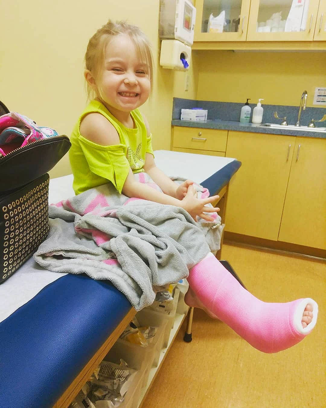 Madison is registered to the contest to win money with this photo: ankle, chair, child, electronic_device, joint, joy, lap, leg, person, play, shoe, sitting