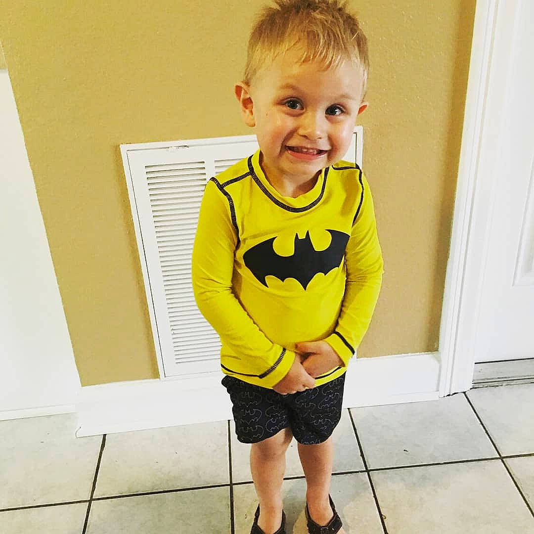 Logan is registered to the contest to win money with this photo: baby, baby_toddler_clothing, child, clothing, footwear, joy, long_sleeved_t_shirt, male, neck, outerwear, person, personal_protective_equipment, shoe, shorts, sleeve, smile, sportswear, standing, t_shirt, toddler