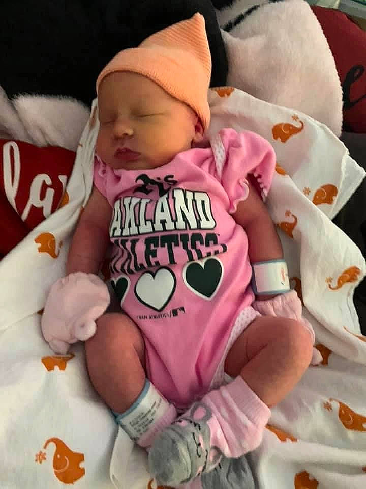 Angel is registered to the contest to win money with this photo: arm, baby, baby_carriage, baby_products, baby_safety, baby_sleeping, baby_toddler_clothing, cheek, child, comfort, finger, font, hand, headwear, linens, person, pink, sleeve, t_shirt, thumb