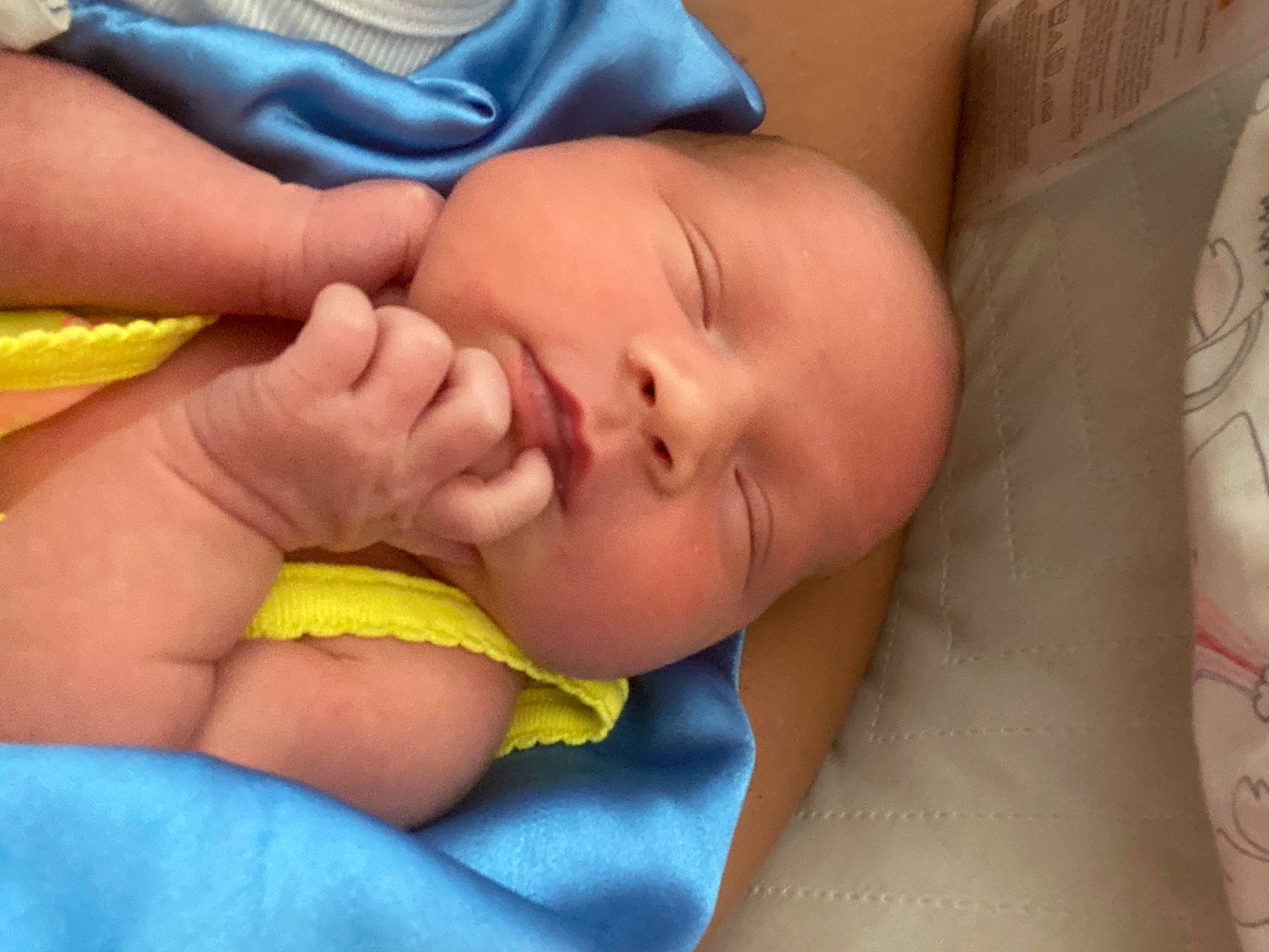 Angel is registered to the contest to win money with this photo: abdomen, baby, baby_sleeping, bedtime, cheek, child, close_up, comfort, face, finger, hand, human_body, human_leg, linens, mouth, nail, nose, person, skin, thumb