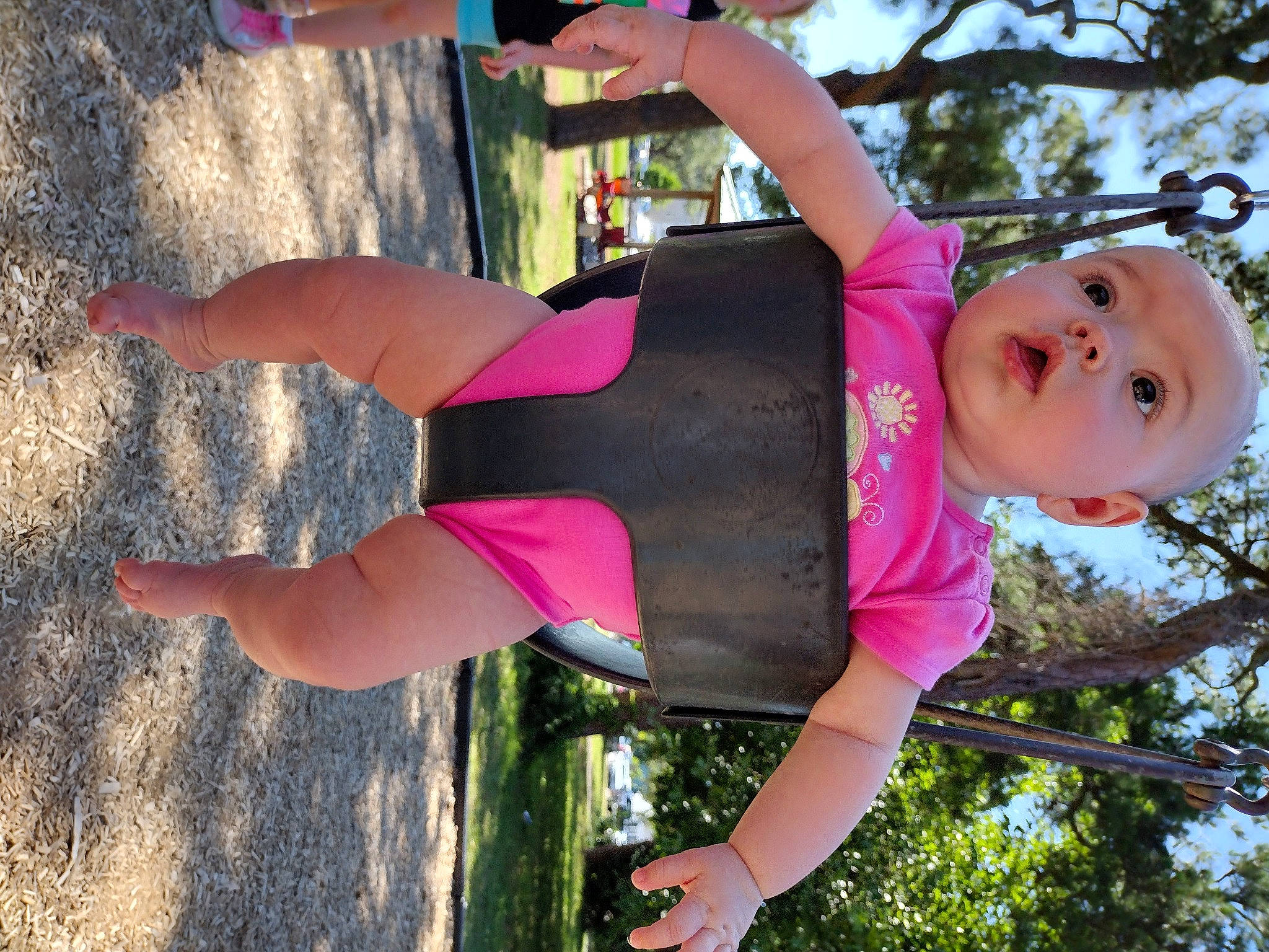 Alannah is registered to the contest to win money with this photo: arm, clothing, elbow, grass, green, happy, joint, leisure, light, magenta, people_in_nature, person, pink, plant, red, smile, summer, surprise, thigh, tree