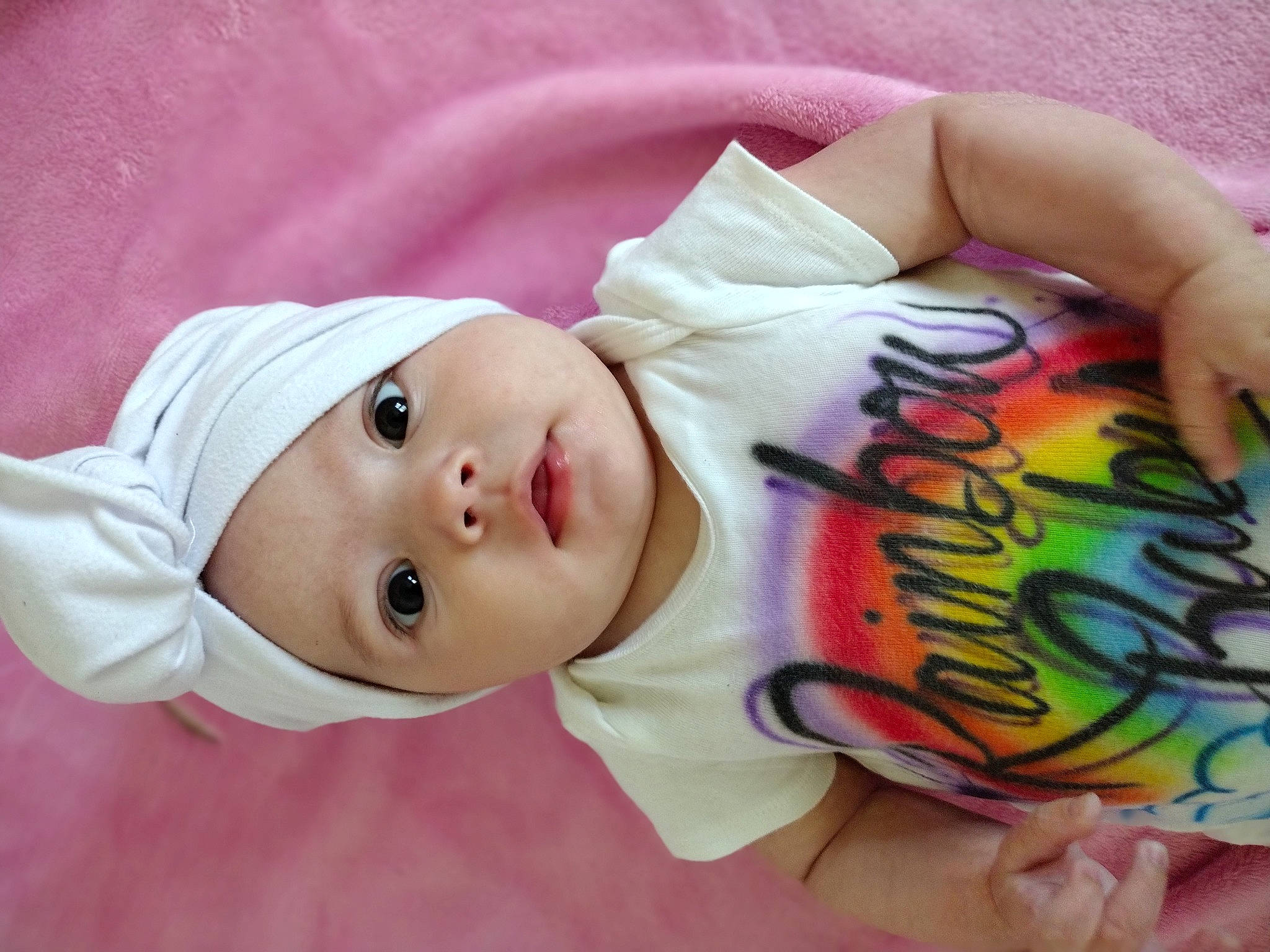 Alannah joined the competition — help win amazing prizes! baby, baby_products, baby_toddler_clothing, cheek, chest, child, eye, eyelash, happy, hat, headwear, linens, lip, nose, pattern, peach, person, pink, skin, sleeve