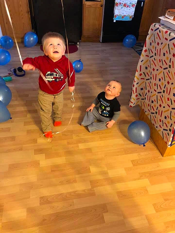 Jackson is registered to the contest to win money with this photo: ball, child, floor, flooring, hardwood, person, play, toddler, wood