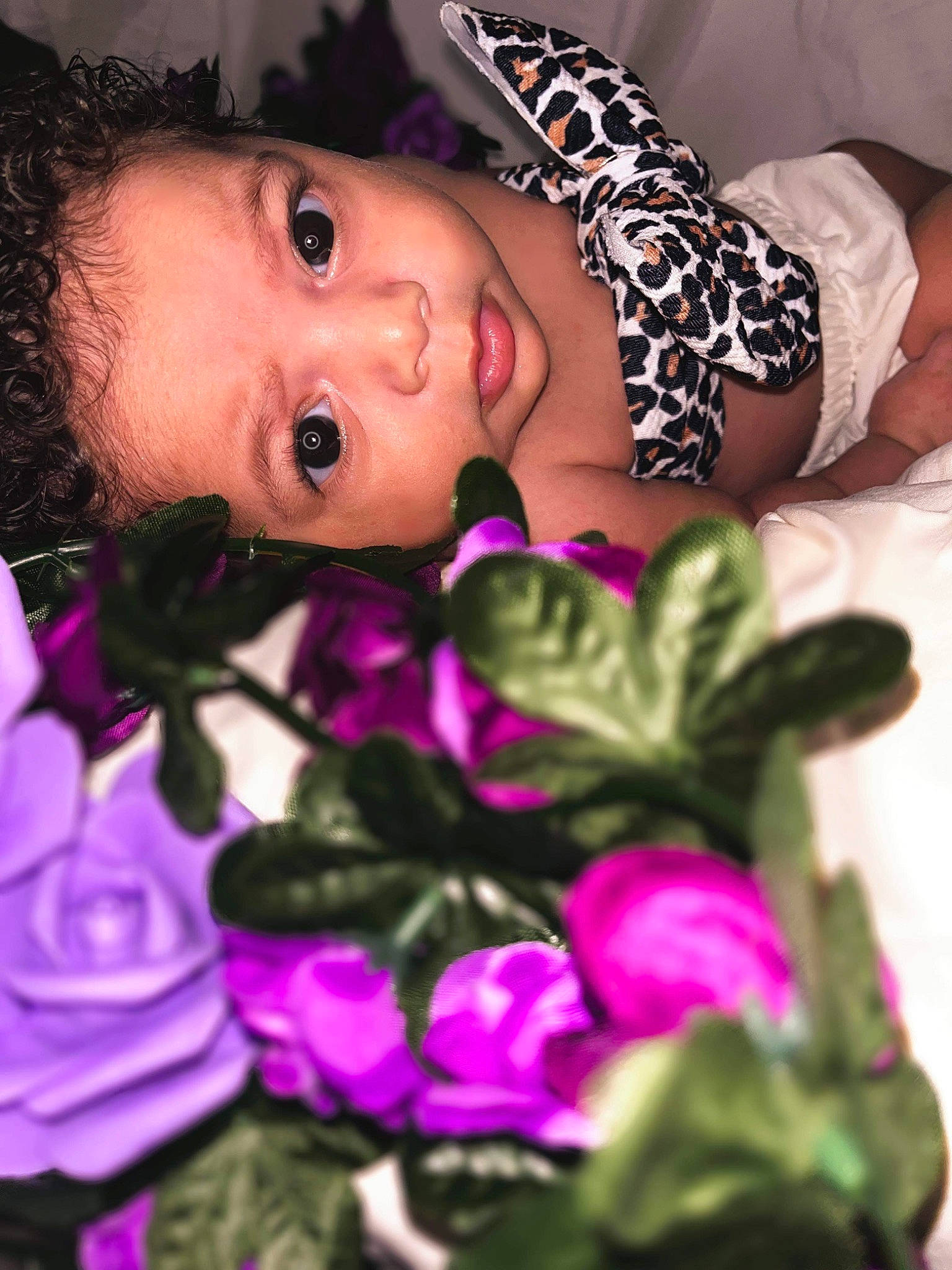 Islyn is registered to the contest to win money with this photo: beauty, child, close_up, eye, eyelash, flower, gesture, happy, iris, leaf, lip, magenta, nail, person, petal, pink, plant, purple, skin, toddler