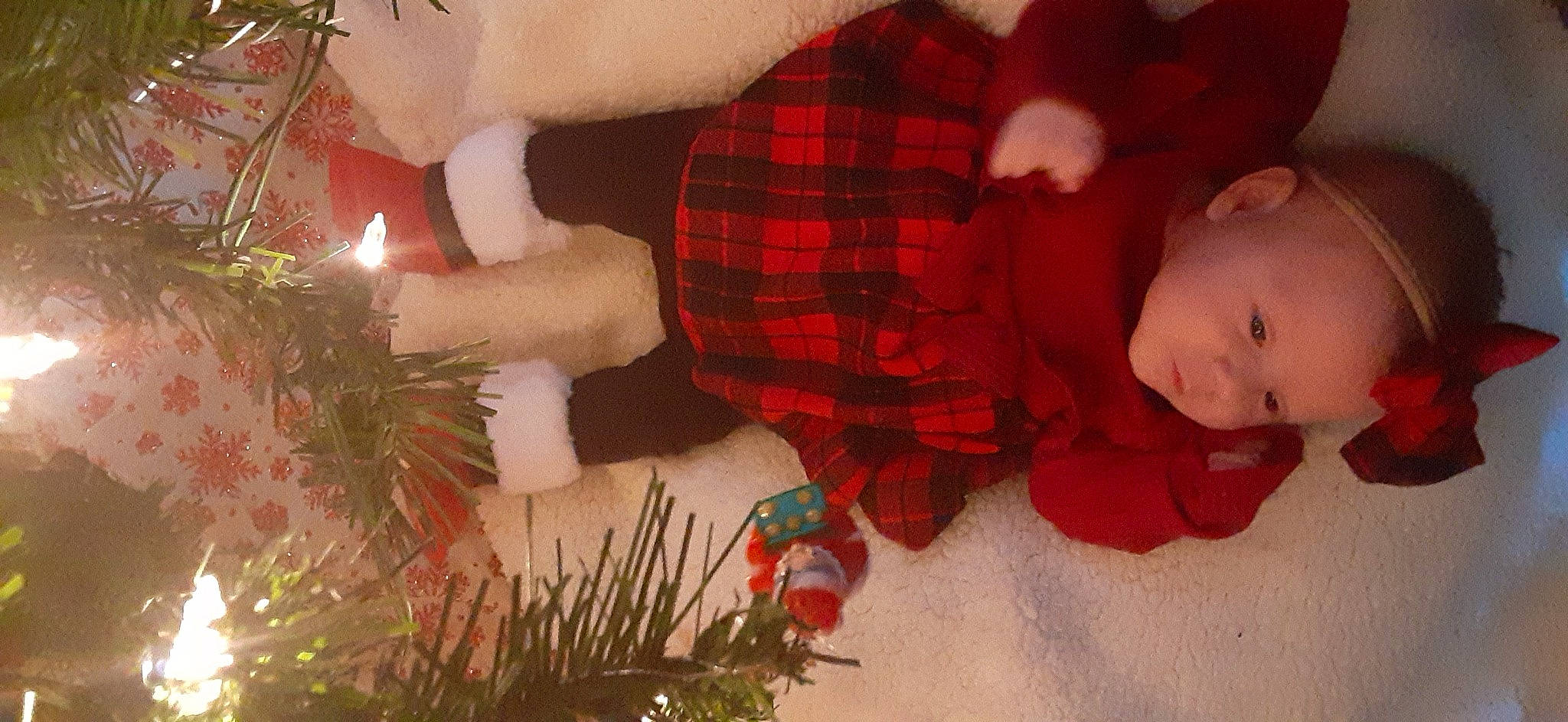 Karley joined the competition — help win amazing prizes! baby, christmas, christmas_decoration, christmas_eve, christmas_ornament, christmas_tree, event, evergreen, head, holiday, holiday_ornament, human_body, ornament, person, plaid, plant, red, smile, tartan, toddler