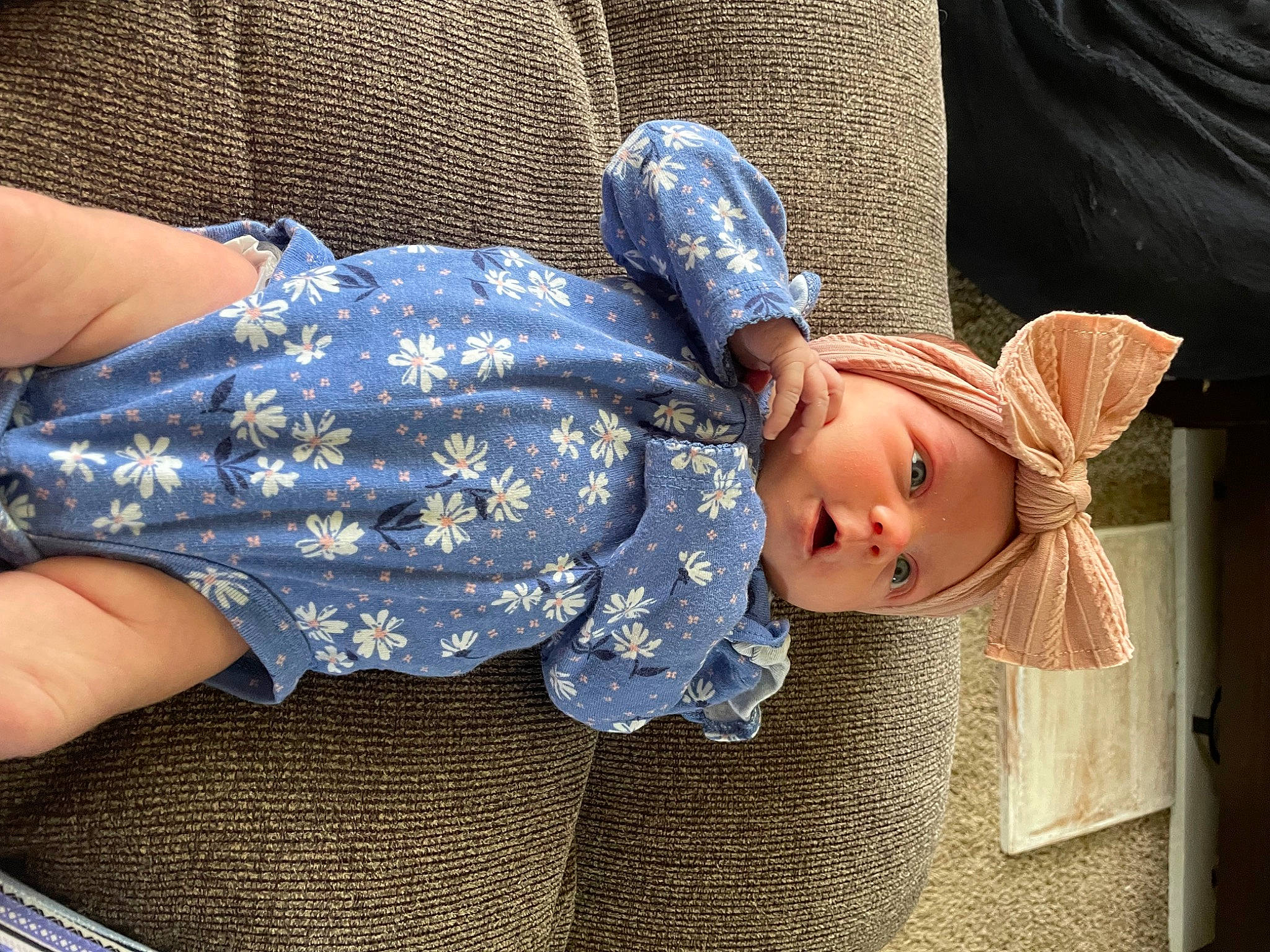 Clementine is registered to the contest to win money with this photo: baby, baby_products, baby_toddler_clothing, blue, child, comfort, dress, electric_blue, finger, gesture, hand, hat, human_body, human_leg, leg, pattern, person, skin, sun_hat, thigh