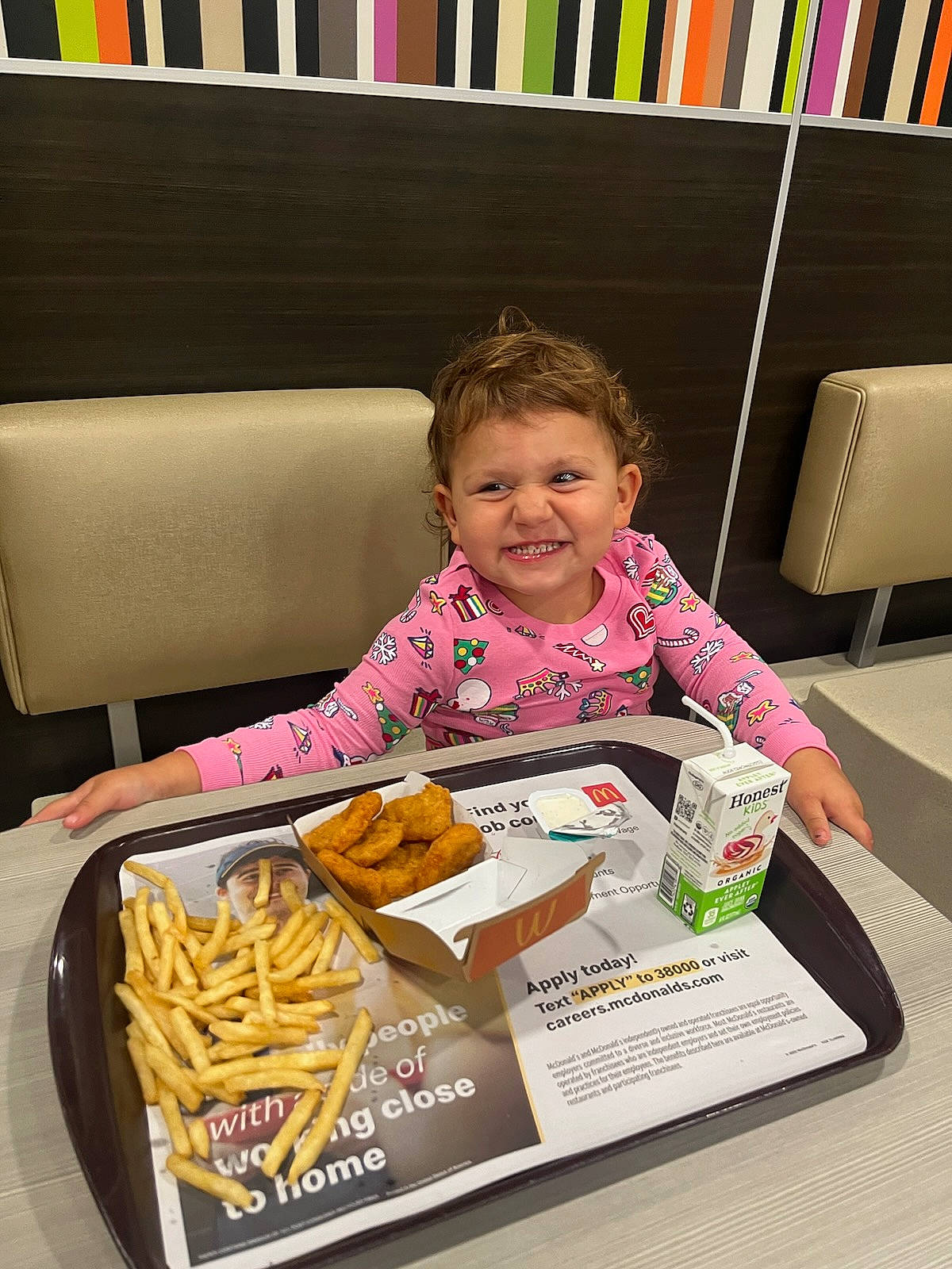 Anniemae is registered to the contest to win money with this photo: bookcase, comfort_food, couch, cuisine, dish, face, finger_food, food, french_fries, happy, joy, junk_food, person, publication, room, sharing, shelf, shelving, sitting, smile