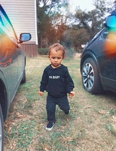 Dontae joined the competition — help win amazing prizes! automotive_design, automotive_exterior, automotive_lighting, automotive_tire, car, cool, fender, grass, land_vehicle, mode_of_transport, morning, motor_vehicle, person, plant, tire, toddler, tree, vehicle, vehicle_door, wheel