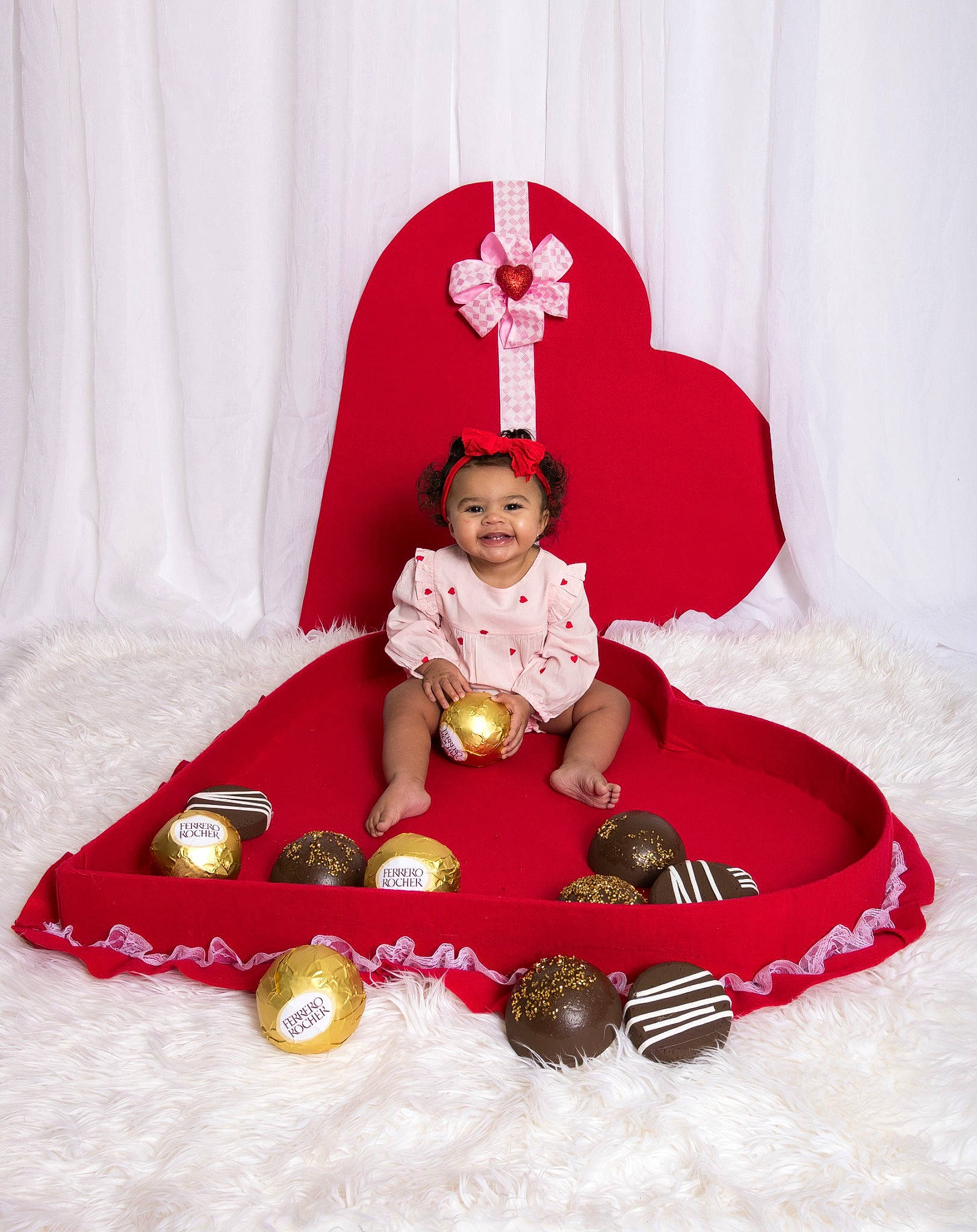 Raelynn is registered to the contest to win money with this photo: baby, baby_toddler_clothing, carmine, chair, christmas_decoration, christmas_eve, clothing, costume_hat, doll, dress, event, hat, head, human_body, joy, magenta, person, red, sitting, sleeve